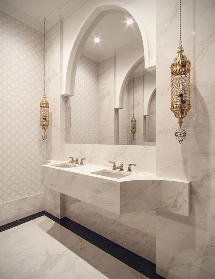 a bathroom with two sinks and an arched doorway in the wall behind them is white marble, classique, marbre