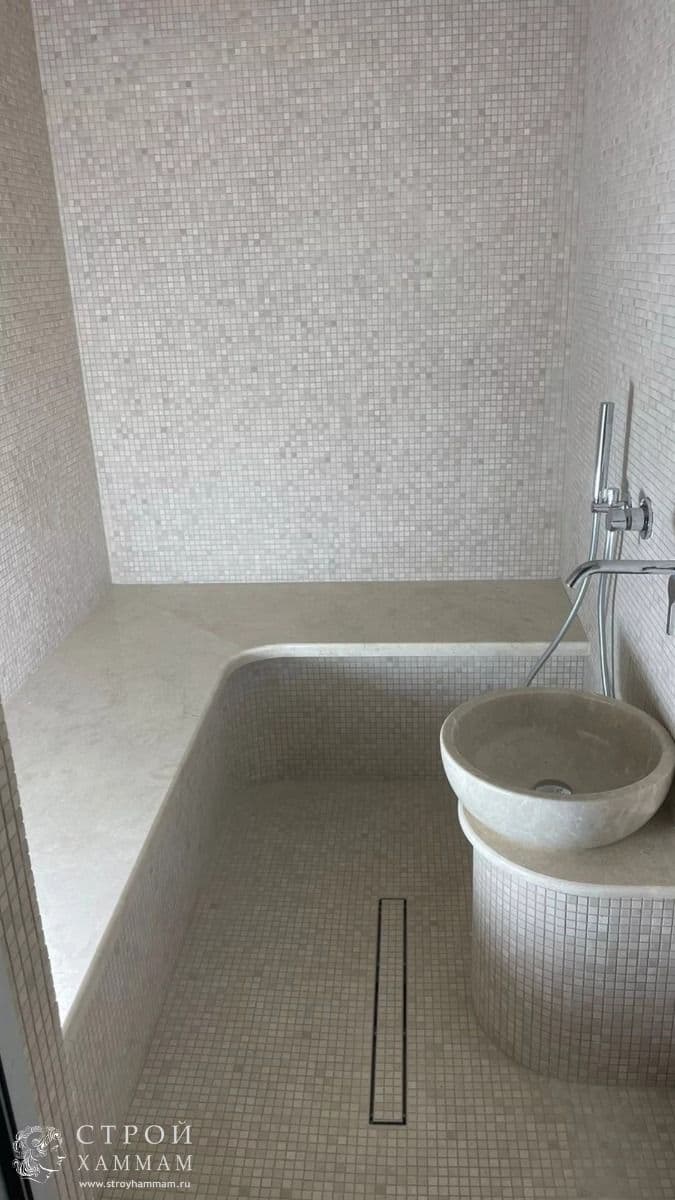 a white toilet sitting next to a bath tub in a bathroom under a faucet, classique, tadelakt